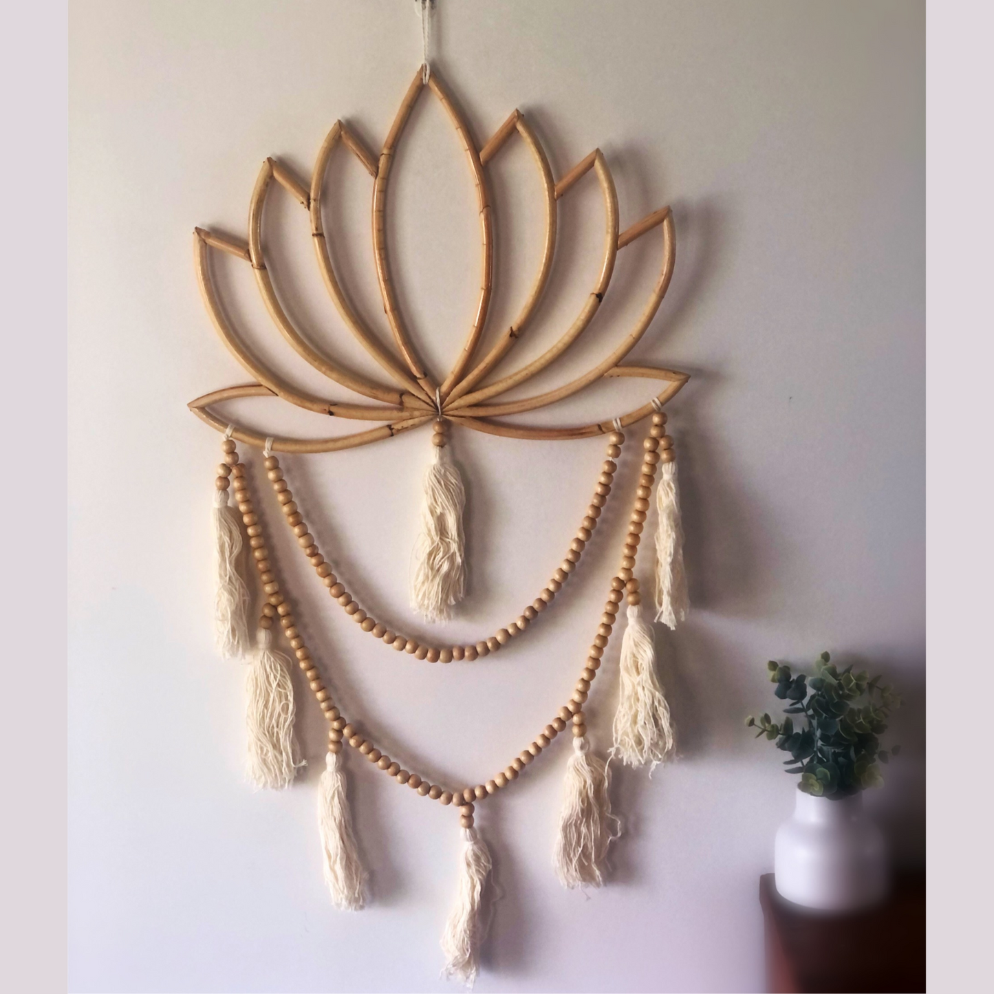 This beautiful design combines beads and tassels falling from a blooming lotus flower. Cream tassels
