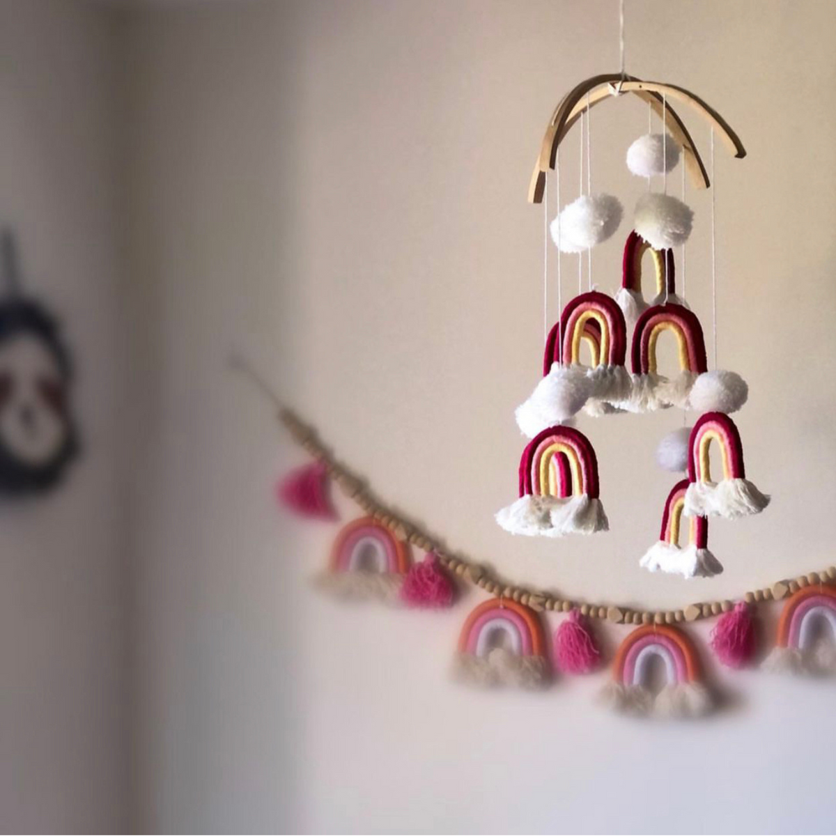 Handmade pom pom rainbow mobile, a colourful boho nursery decor piece and baby gift Australia.