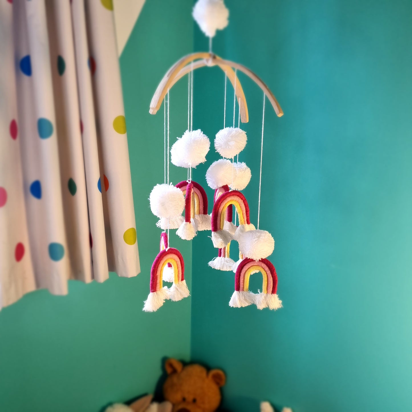 Handmade pom pom rainbow mobile, a colourful boho nursery decor piece and baby gift Australia.