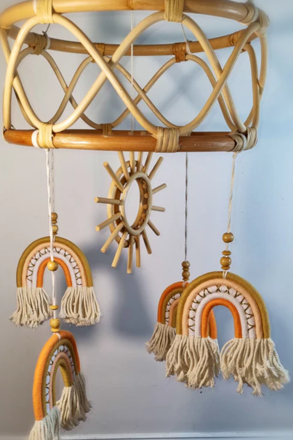 Full view of large boho rattan sun and rainbow baby mobile showing natural rattan frame, wooden sun and macrame rainbow pendants — boho nursery decor Australia