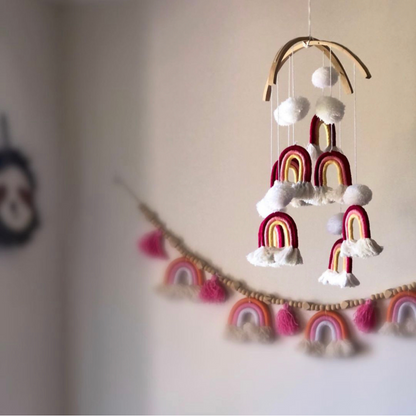 Handmade pom pom rainbow mobile, a colourful boho nursery decor piece and baby gift Australia.