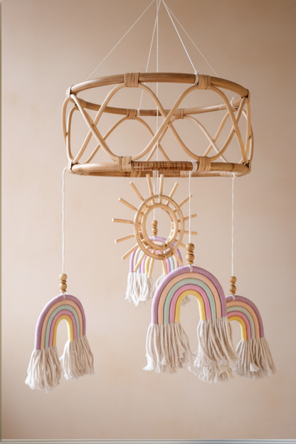 Close-up detail of boho rattan baby mobile showing blue macrame rainbow with cream tassels and wooden beads — large rattan mobile Australia