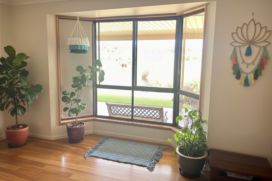 Macrame rectangle mat in steel blue diamond weave pattern with fringe edge on a light tiled floor — boho nursery and home decor rug Australia