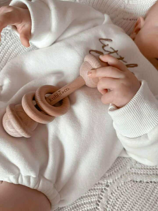Natural wood and cotton baby rattle — soft sensory toy for newborns