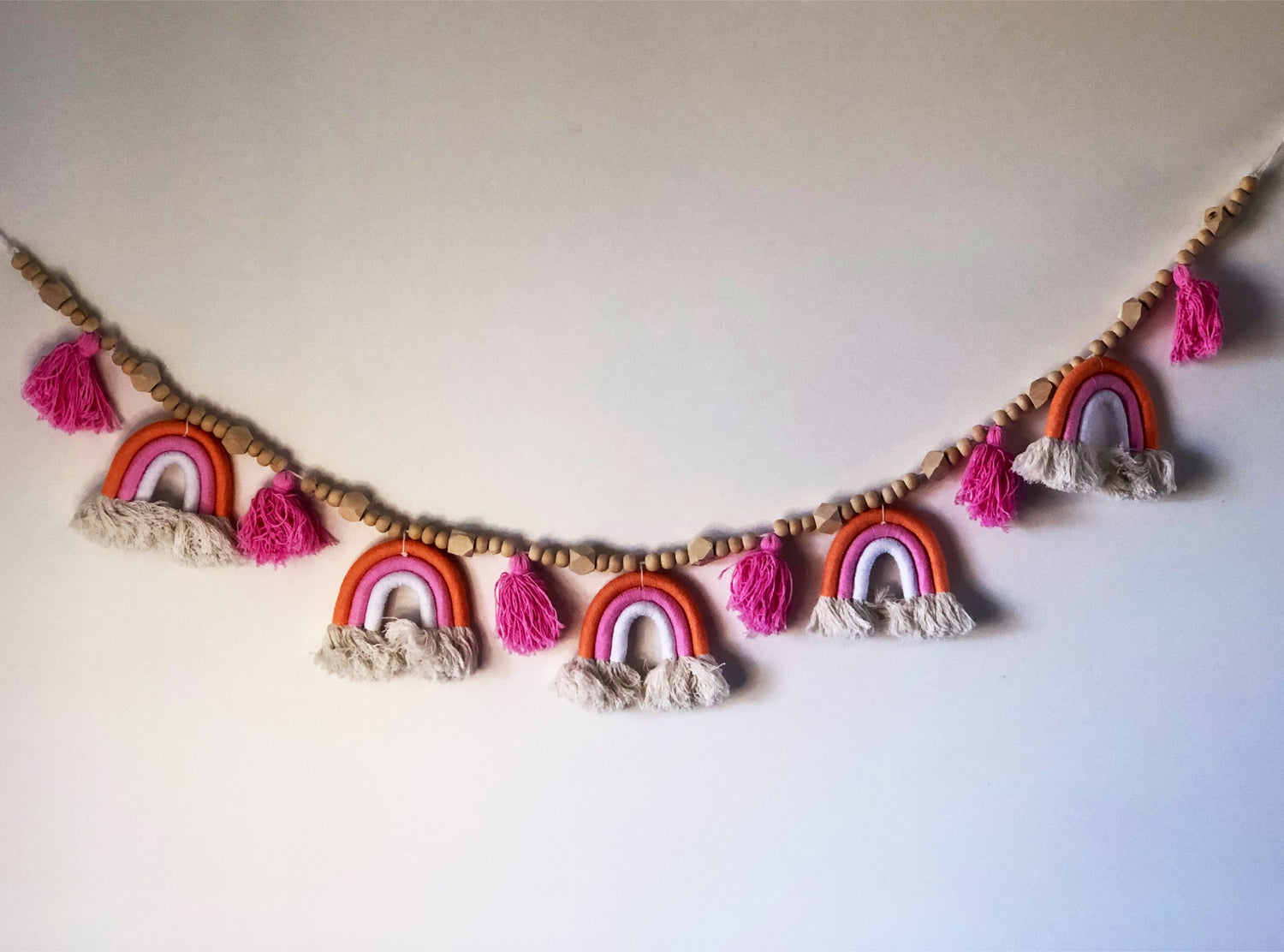 Macrame rainbow bunting garland, soft boho nursery wall decor and handmade baby gift Australia.