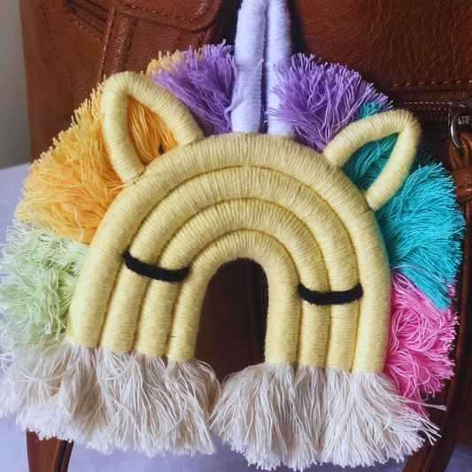 A colorful macrame unicorn key chain with a mane and tail. Wonderful accessory for any bag or suitcase.